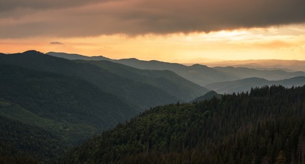 scenic mountains scene, stunning summer dawn landscape, hills covered forest on background morning valley in golden sunlight and dramatic sky, Ukraine, Europe, Carpathian mountains