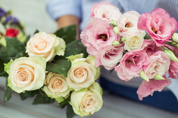 Female florist making beautiful bouquet at flower shop