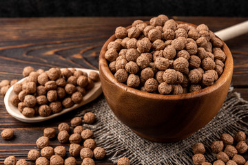Chocolate dried balls on dark wooden background. 