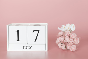 July 17th. Day 17 of month. Calendar cube on modern pink background, concept of bussines and an...