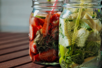 Two glasses of lemonade shot from overhead view on rustic table top.