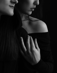 fashion black and white photo of two beautiful girls with dark hair
