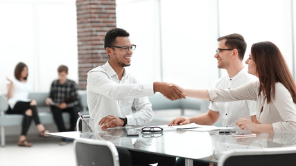handshake of business people in the lobby of the modern business center.
