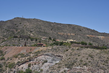 Obraz premium Jerome, AZ. U.S.A. May 18, 2018. A National Historical Landmark 1967, Jerome’s Cleopatra hill tunnel/open pit copper mining boom 1890s to bust 1950s. Jerome offers by-ways, B&Bs, hotels, saloons