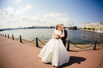 Obraz premium Wedding. Bride and groom walk outdoors