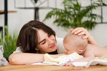 Mother smile caress touch baby girl head