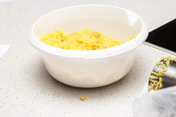 White bowl of mashed potatoes to be used as a filling in a pie. Baking concept