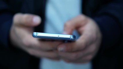 Close-up View of Man Using Smartphone in the city street