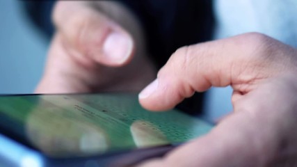 Close-up View of Man Using Smartphone in the city street