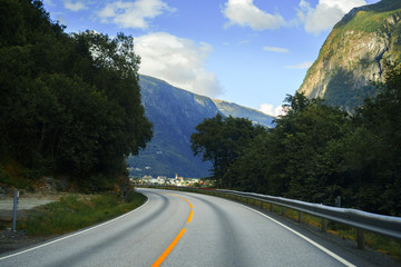 Naklejka premium spellbinding landscape of Norwegian nature roads among high charming mountains and hills in which it is impossible not to fall in love