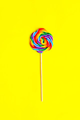 Colorful candy on yellow background