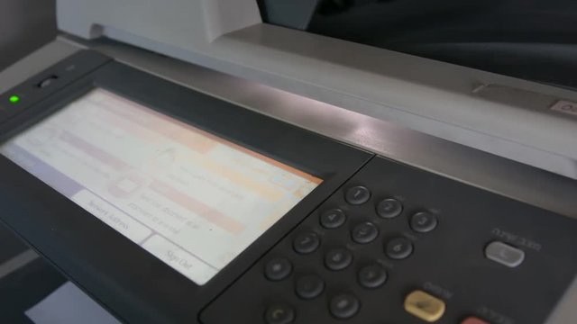 Close up of laser printer. Printed leaves come out of the machine