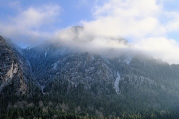 Obraz premium Mountain with clouds near Neuswanstein castle. Bavaria, Germany.