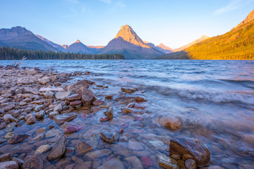 The morning sun hits the peaks at Two Medicine Lake in Montana