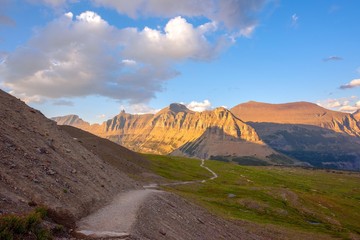 Trail leading to mountains at sunset - Glacier national park