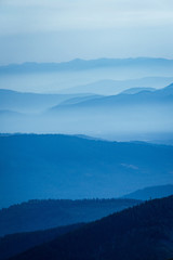 Smoke filled mountain layers in summer due to wildfires