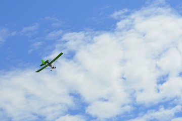 Sports plane in the sky performs aerobatics
