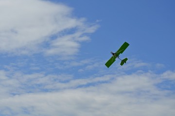 Sports plane in the sky performs aerobatics