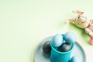 Blue easter eggs on pastel green background. Festive symbol stille life