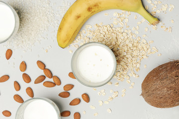Assortment of organic vegan non-dairy plant-based milk in glasses, top view