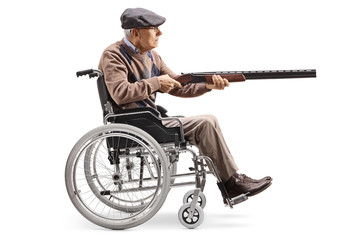Elderly man in a wheelchair aiming with a shotgun