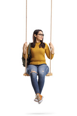 Female student on a swing looking away
