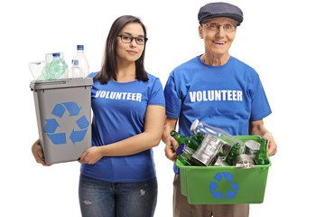 Young female volunteer and a senior man volunteer with recycling bins