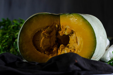 Fresh yellow pumpkin on an old tray with vegetables