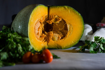 Fresh yellow pumpkin on an old tray with vegetables