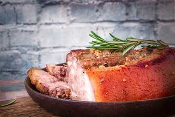 Fried juicy barbecue meat baked in the oven on a baking sheet with french mustard