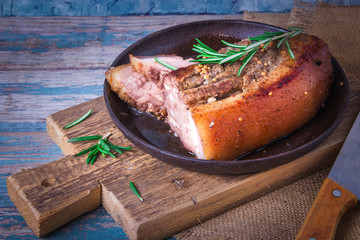 Fried juicy barbecue meat baked in the oven on a baking sheet with french mustard