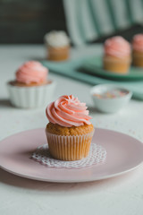 Cupcakes decorated with pastel pink plate and pastel green towel