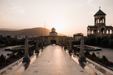 Fototapeta premium cathedral in Tbilisi, Georgia, covered in orange sun lit during sunset