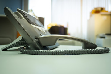 Closeup ip phone and headphone on the desk office