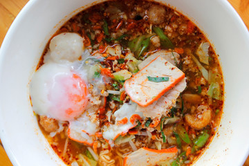spicy red pork noodles soup with soft-boiled egg