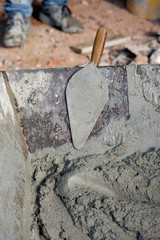 Closeup of trowel on the wheelbarrow with mortar