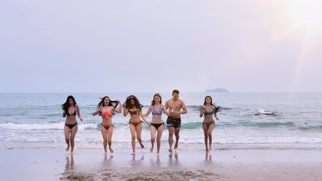 Asian friends group. Men and women in bikini Celebration enjoy on the beach summer holidays vacations. Concept freedom, Lifestyle, tourism, holiday, celebration. Slow Motion