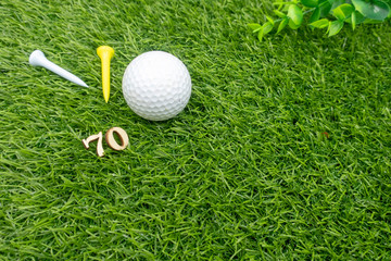 70th birthday with golf ball and tees are on green grass