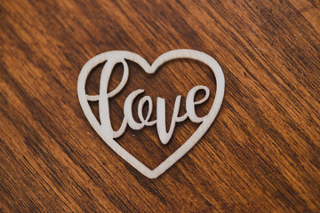 Wooden hearts with "love" engraved inside on wood surface