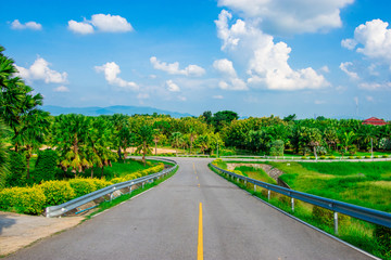 street view with green mountain on blue sky background in the province of Thailand. decoration image contain certain grain noise and soft focus.