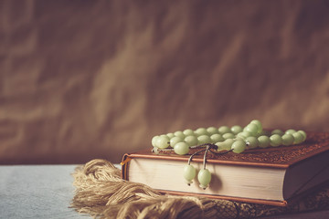 The Holy Quran with rosary and praying carpet. Image of The Holy Quran with rosary. Muslim Rosary...
