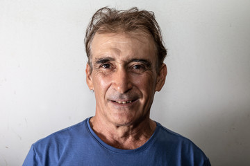 Fototapeta premium Older man laughing on white background.