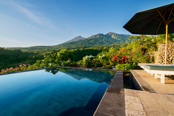Fototapeta na wymiar Swimming pool with beautiful Rinjani mount view