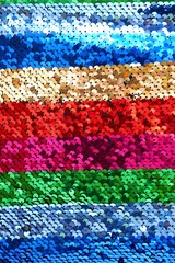 Sequins background.sequins striped fabric.Texture scales with Sequins close-up.Sequins multicolored...