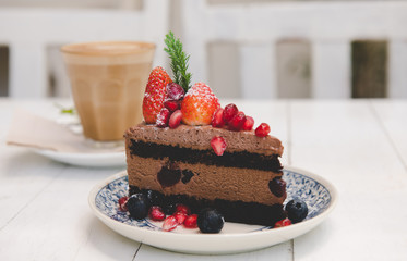 Chocolate cake topping with strawberry and berry fruits.