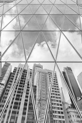 Reflection of urban skyline on modern office building