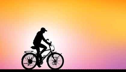 Fototapeta na wymiar Silhouette man and bike relaxing on blurry sky background.