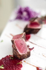 gourmet seared tuna in black pepper crust with beetroot coulis