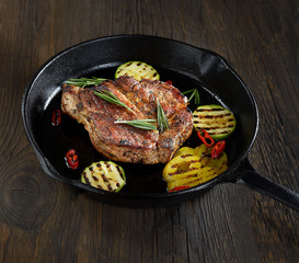 grilled steak in a pan on a wooden background