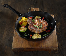 grilled steak in a pan on a wooden background
